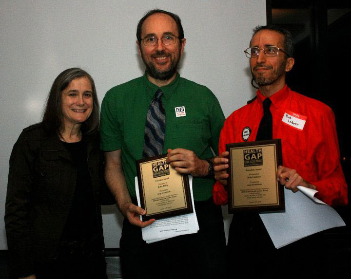 Amy Goodman Presents John Riley and Bob Lederer Health Gap's Global Health Justice Award Amy Goodman presents John Riley & Bob Lederer with Health GAP's Global Health Justice Award