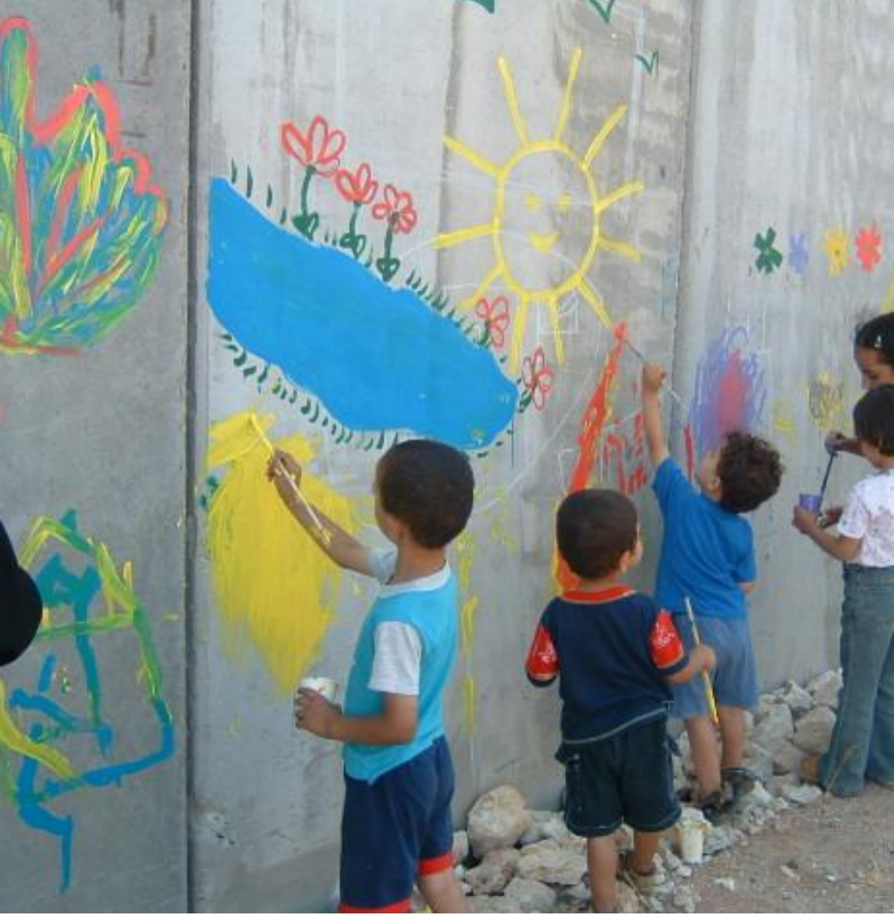 Children drawing on Apartheid Wall in the West Bank